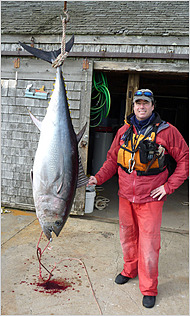 Dave Lamoureux with the 157-pound bluefin, a record tuna for an unassisted kayak fisherman.  Copyright NY Times.